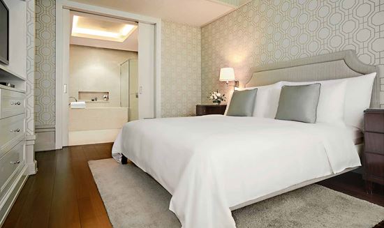 King-sized bed in One Bedroom Suite City View